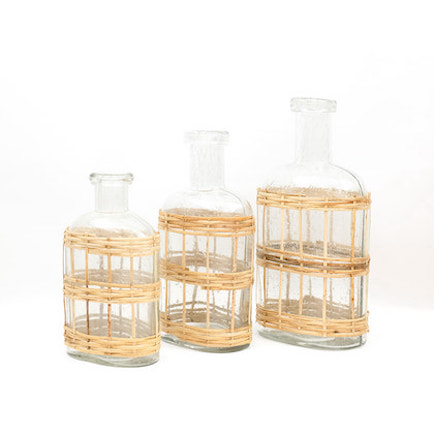 Recycled hand-blown glass wrapped with natural wicker, woven around displayed in three availed sizes.